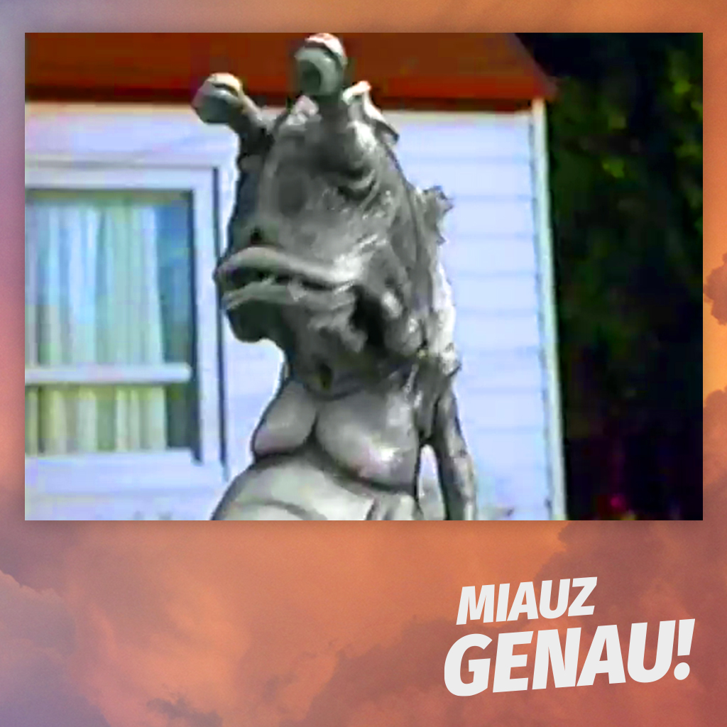 Graue Monsterfigur aus dem Pokémon Gym Challenge Werbespot zum TCG-Set vor einem Haus, eingebettet in das orangefarbene Design von Miauz Genau Folge 176.
